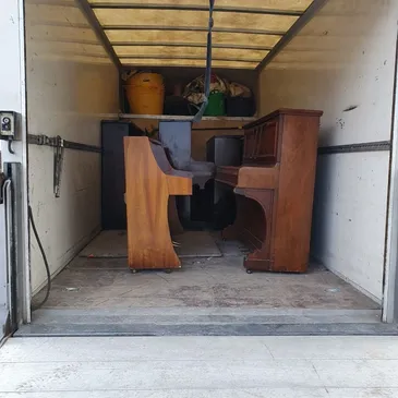Two pianos in the back of a Van